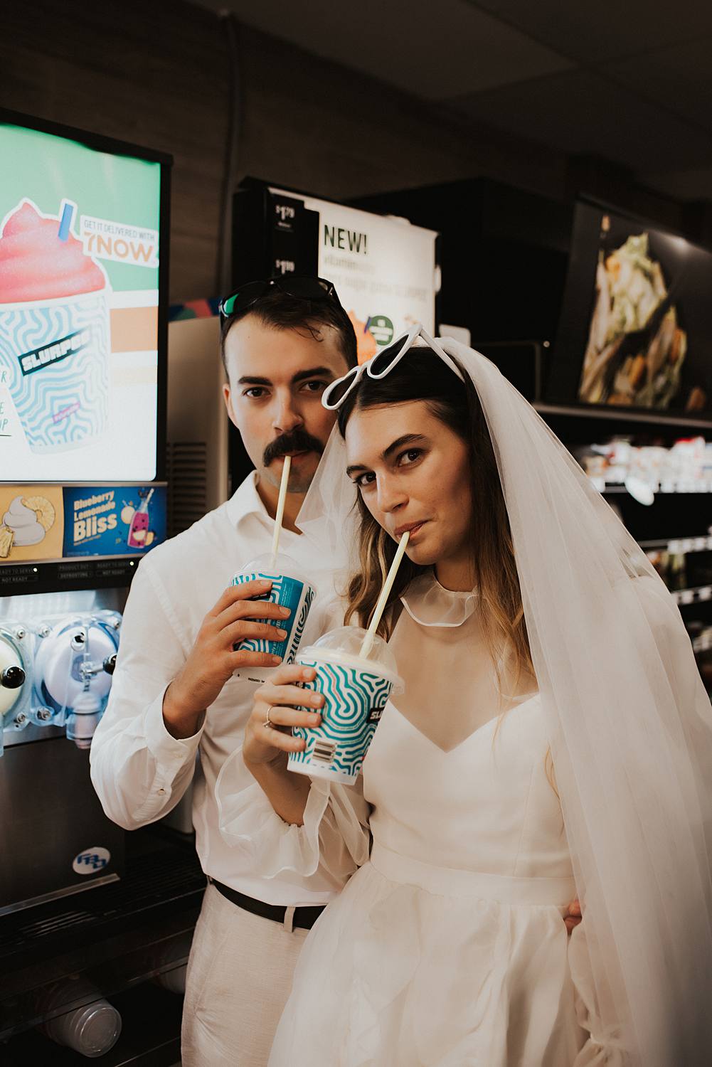 Bride and groom filling slurpie cups at 7 eleven
