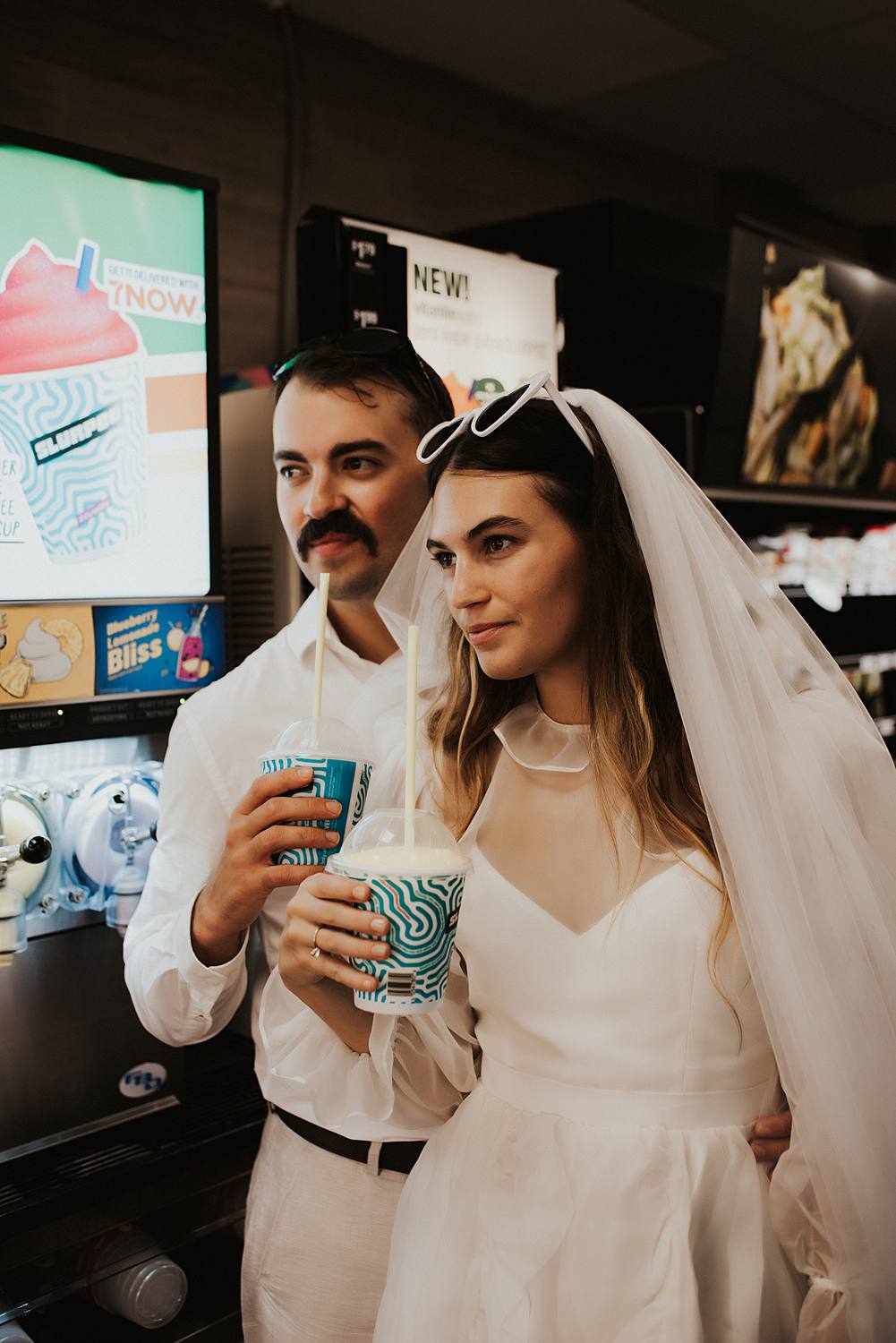 Bride and groom filling slurpie cups at 7 eleven