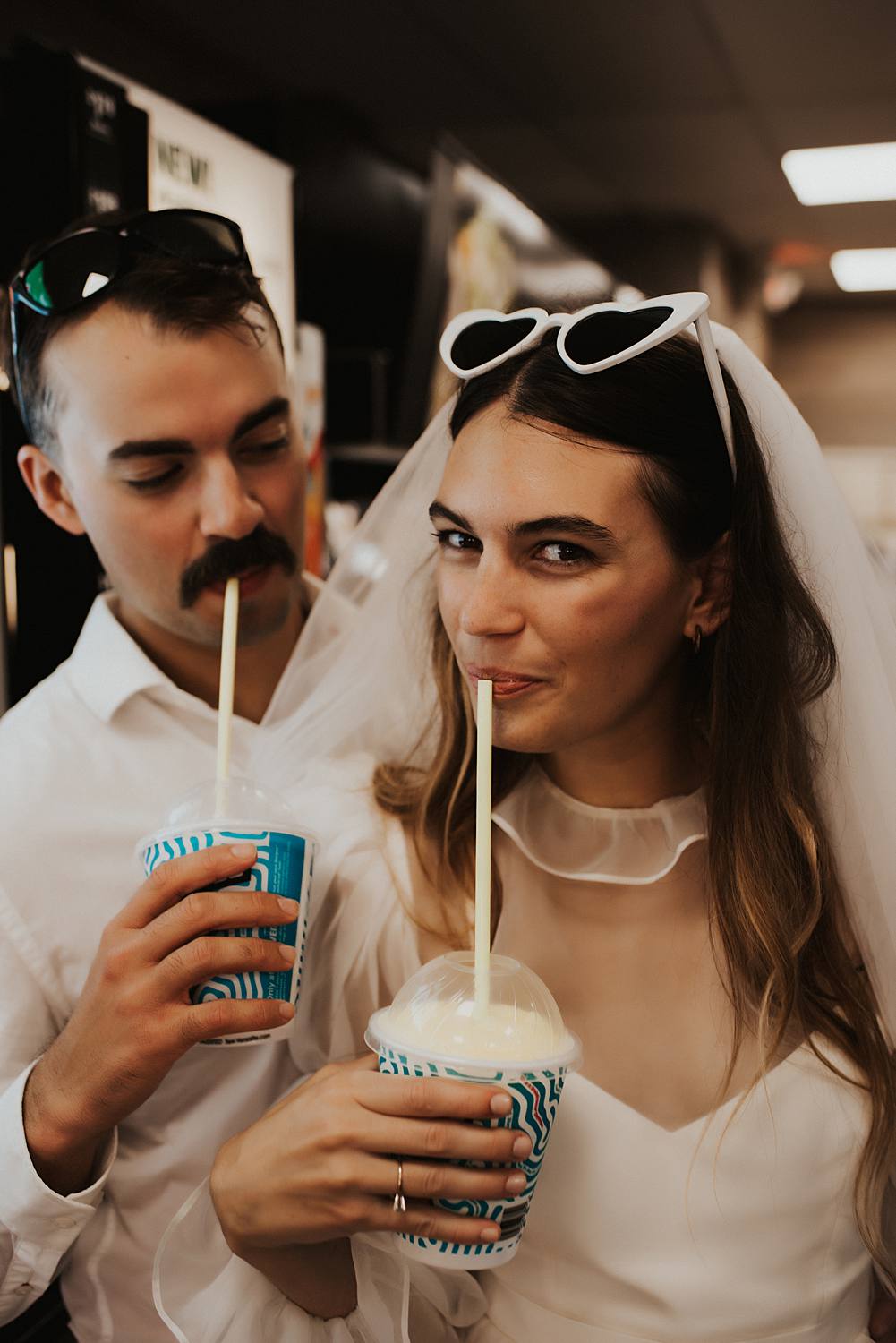 Bride and groom filling slurpie cups at 7 eleven