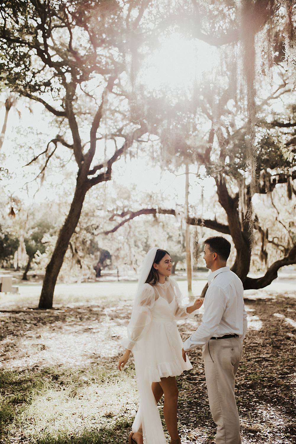Bride and groom under oak trees