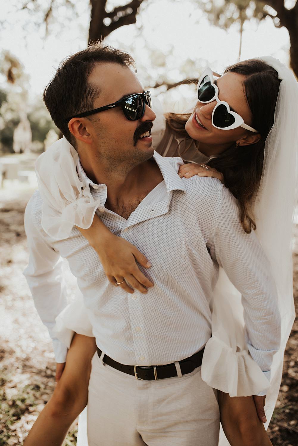 Bride and groom under oak trees