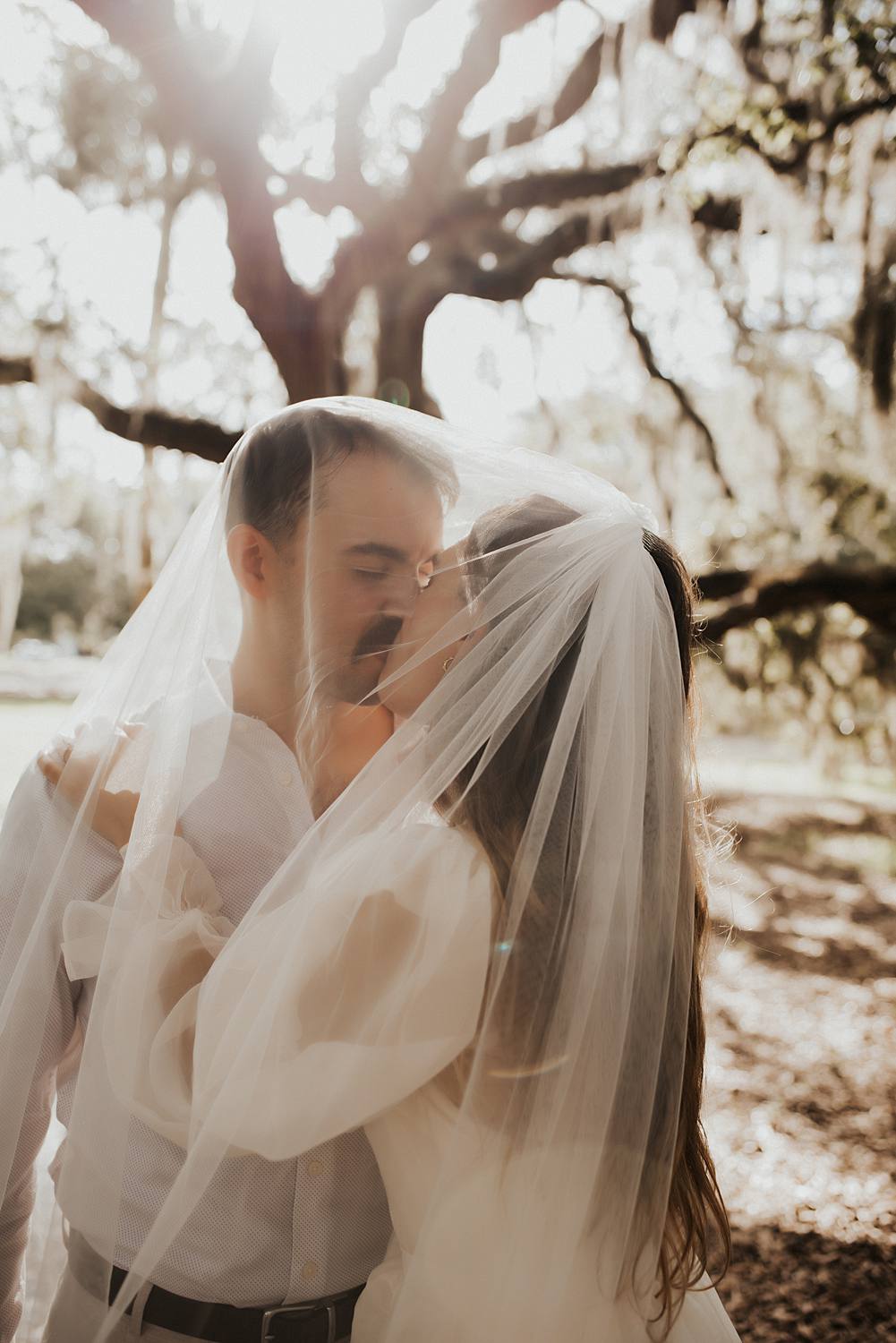 Bride and groom under the veil