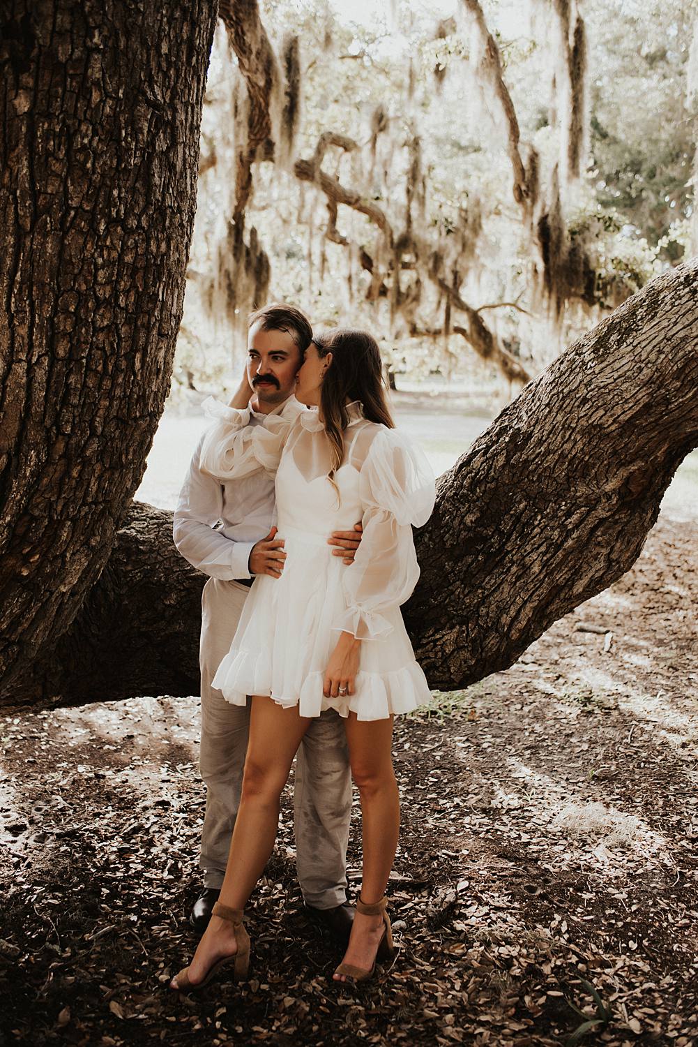 Bride and groom under oak trees