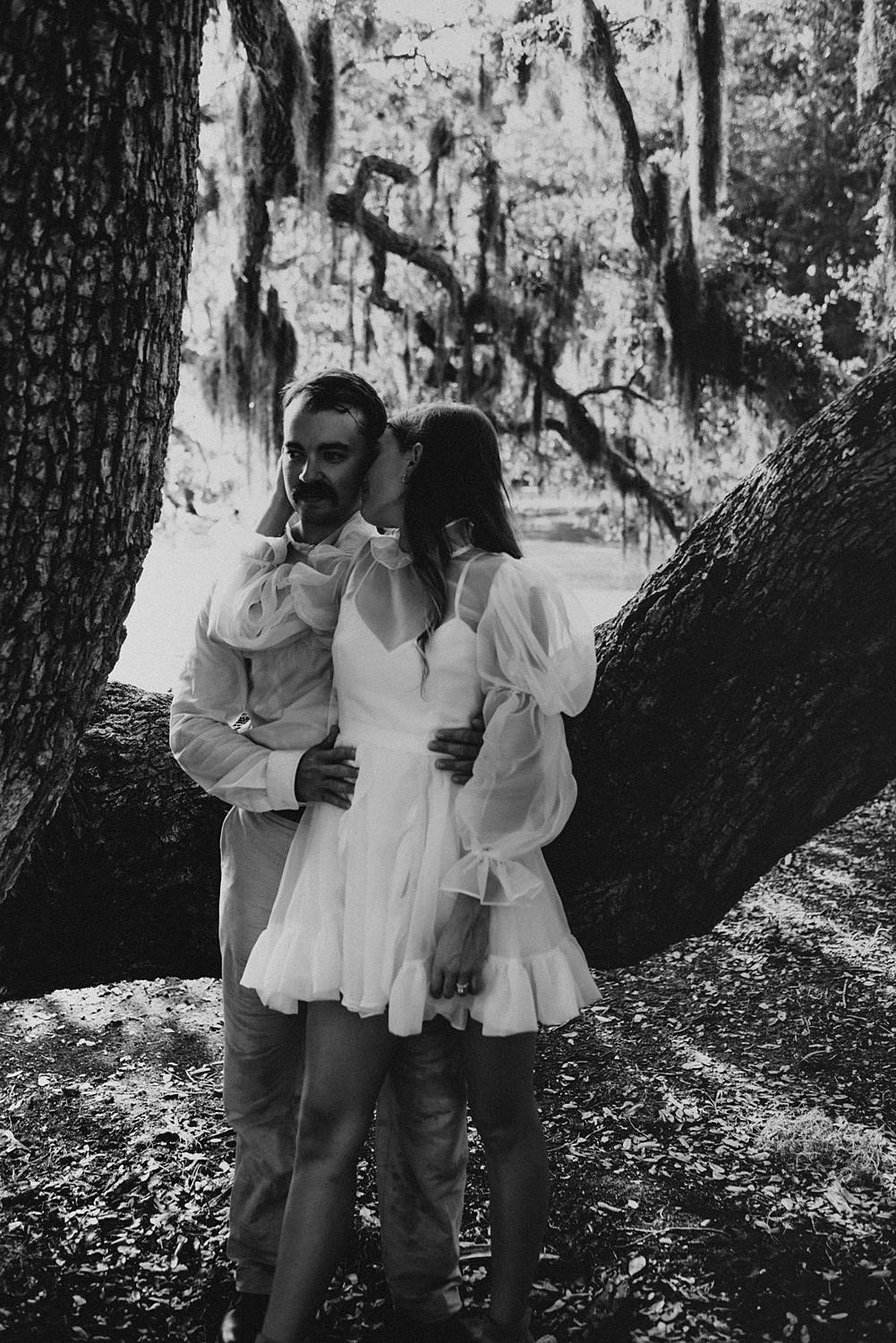 Bride and groom under oak trees