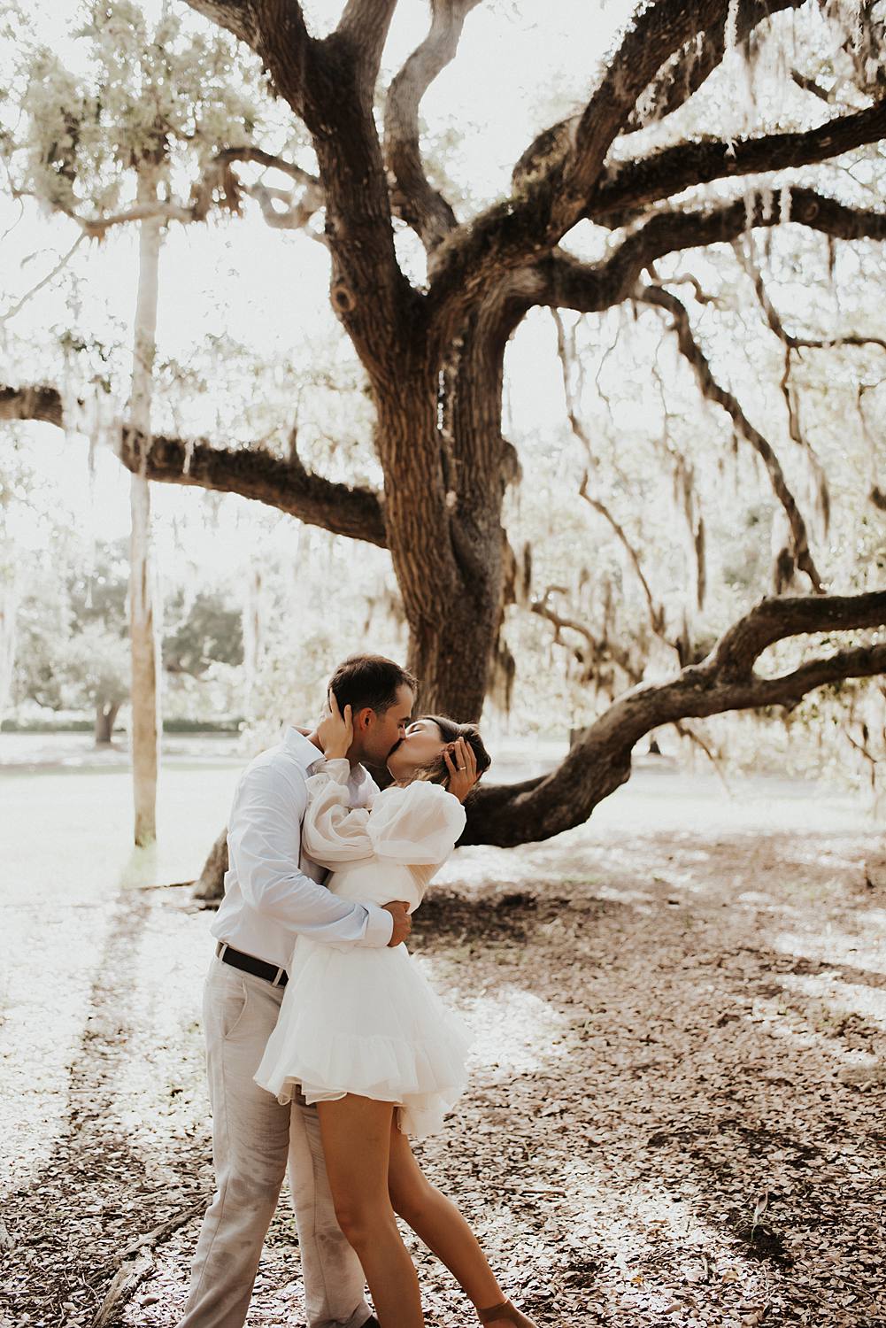 Bride and groom under oak trees