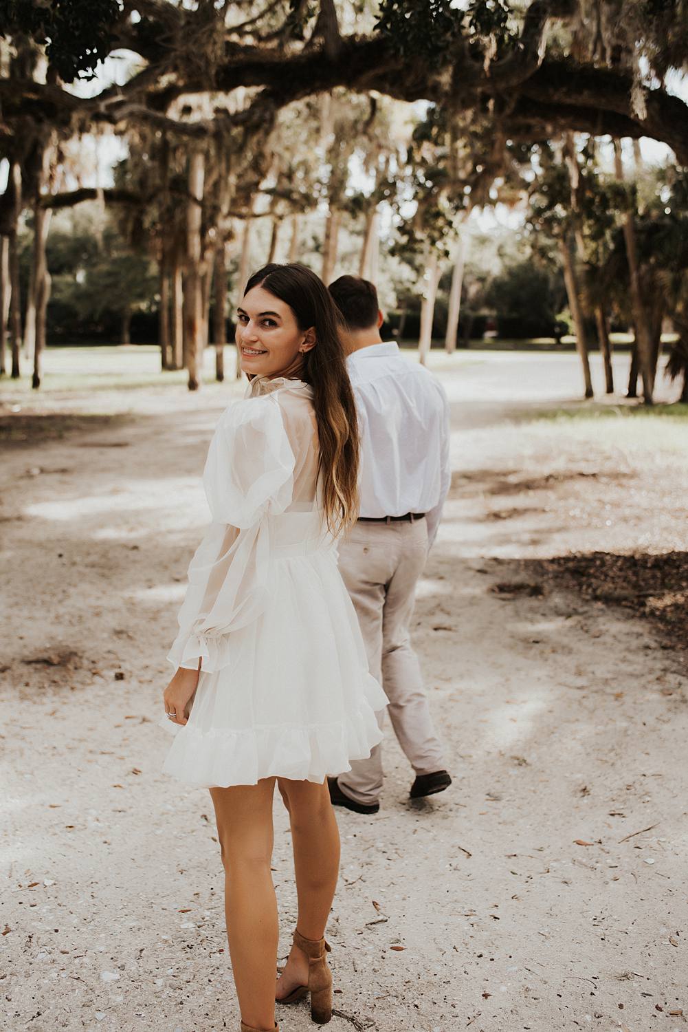 Bride and groom under oak trees