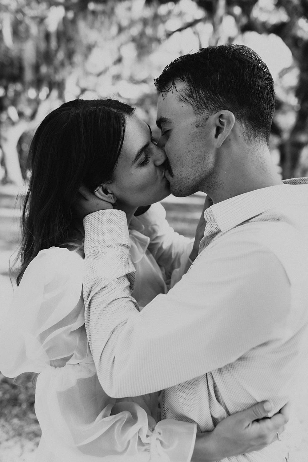 Bride and groom under oak trees