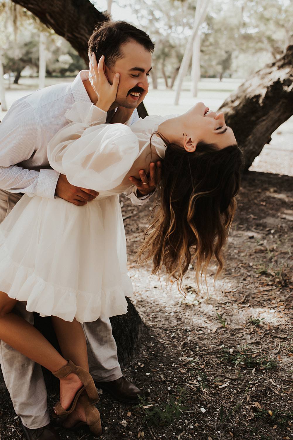 Bride and groom under oak trees