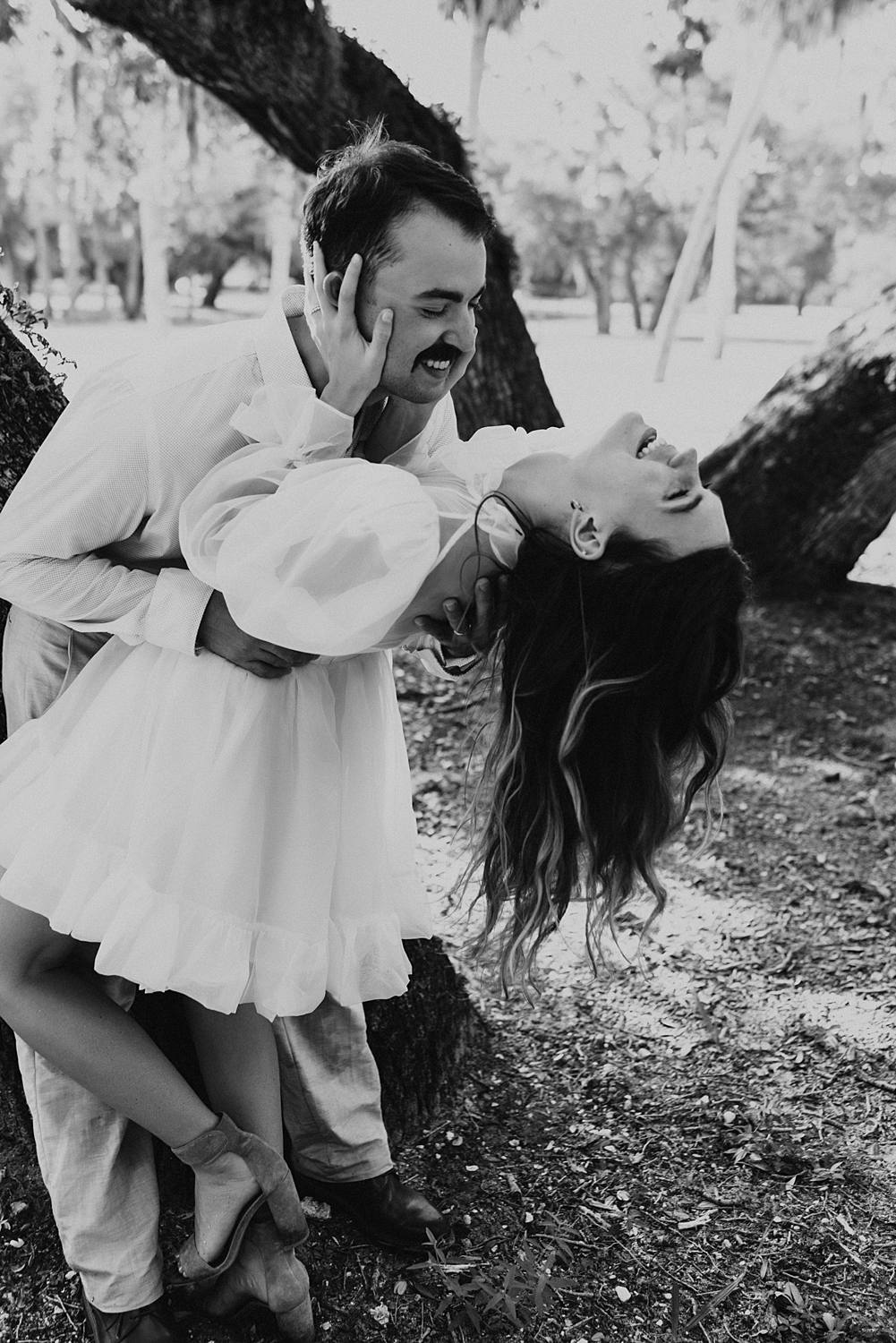 Bride and groom under oak trees