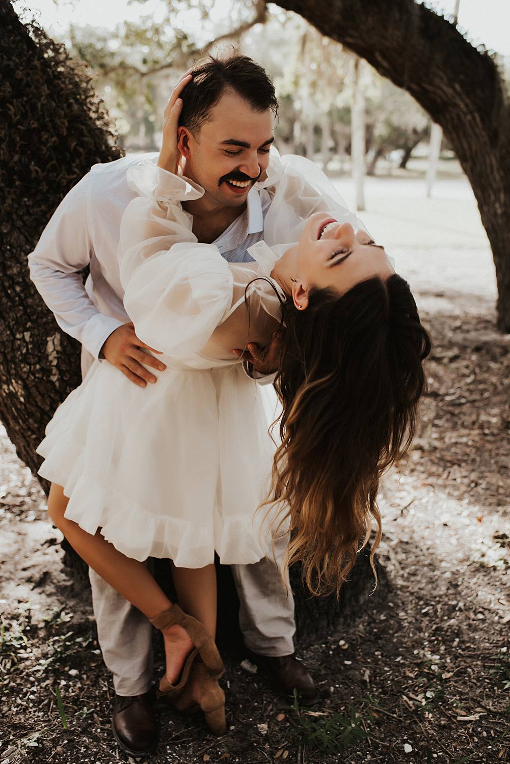 Bride and groom under oak trees