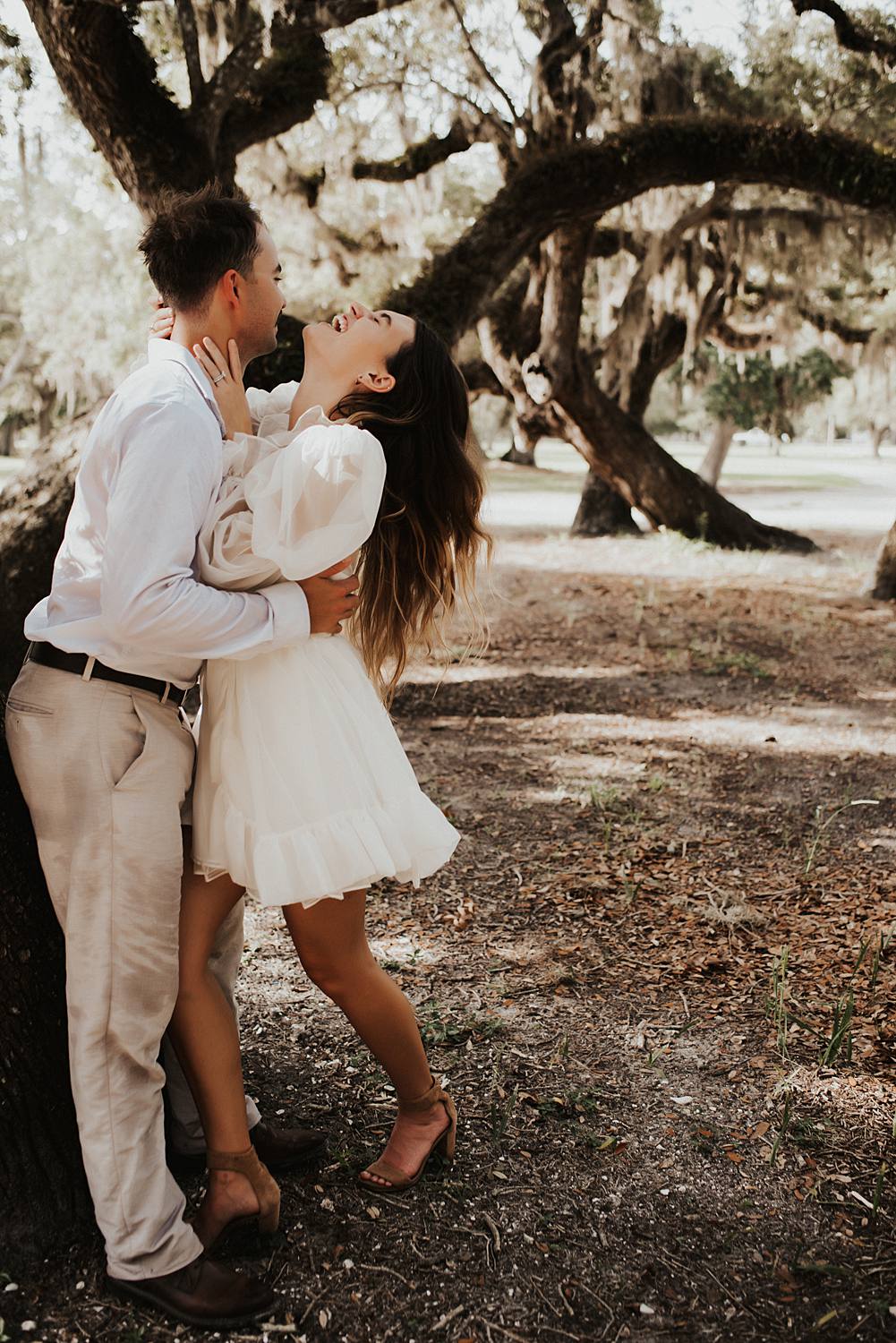 Bride and groom under oak trees