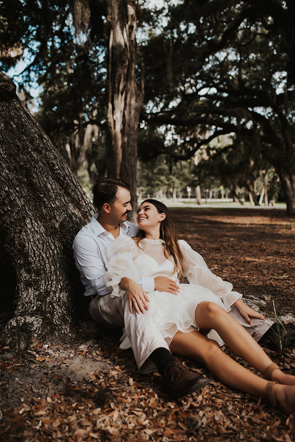 Bride and groom under oak trees