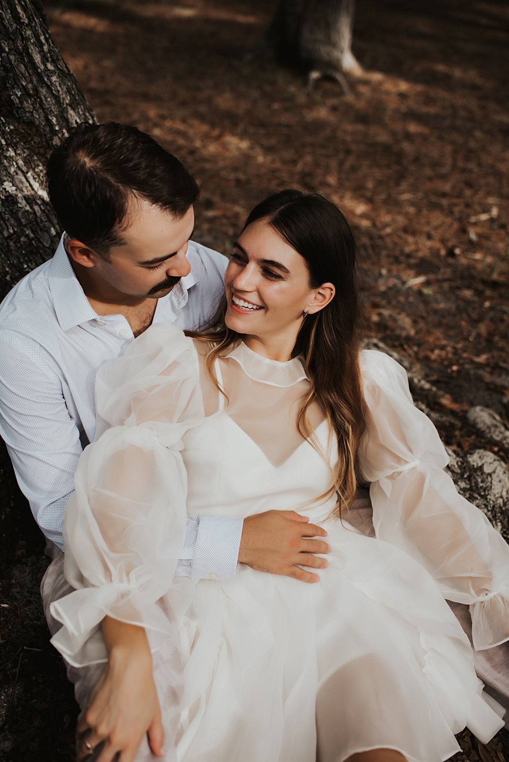 Bride and groom under oak trees