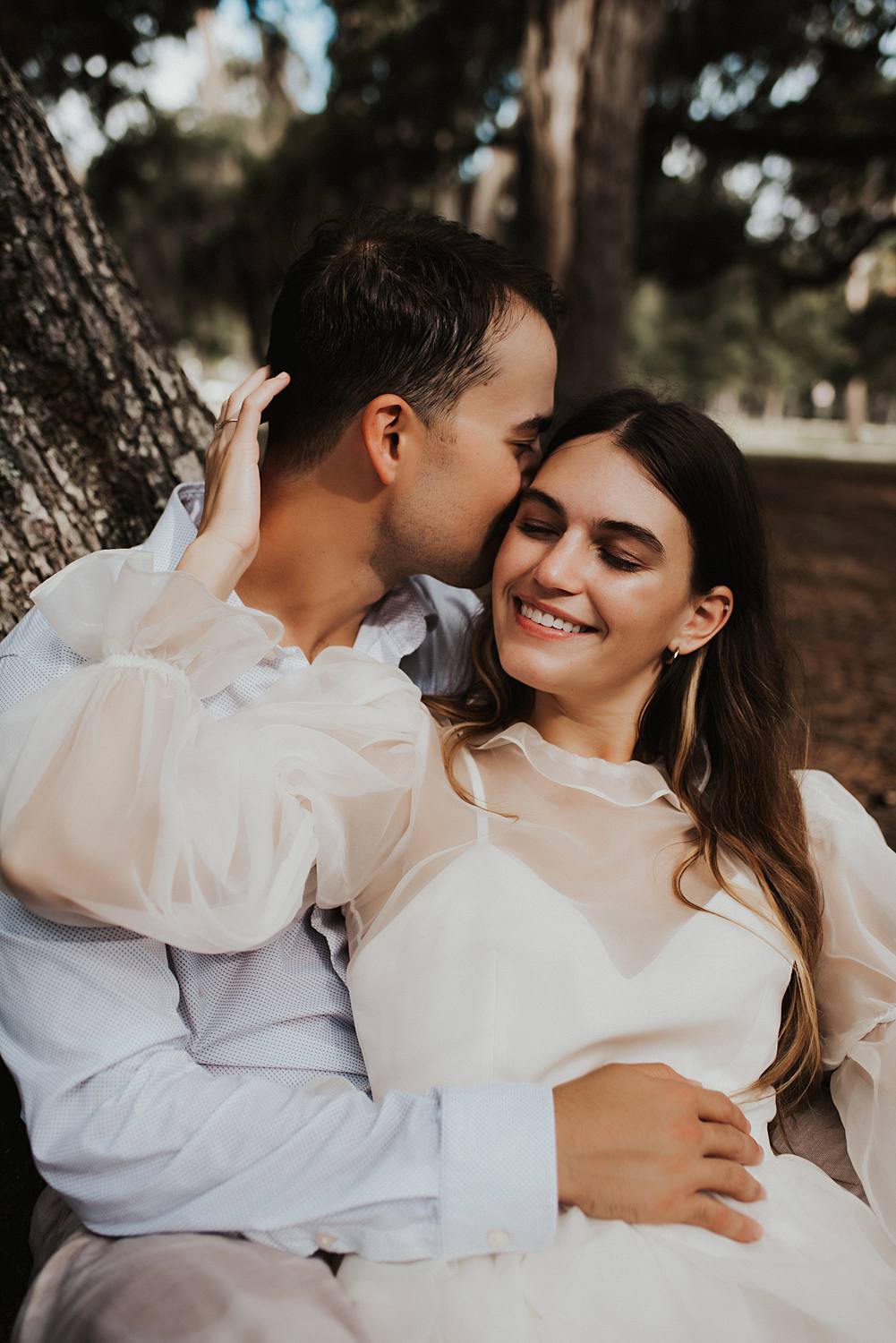 Bride and groom under oak trees