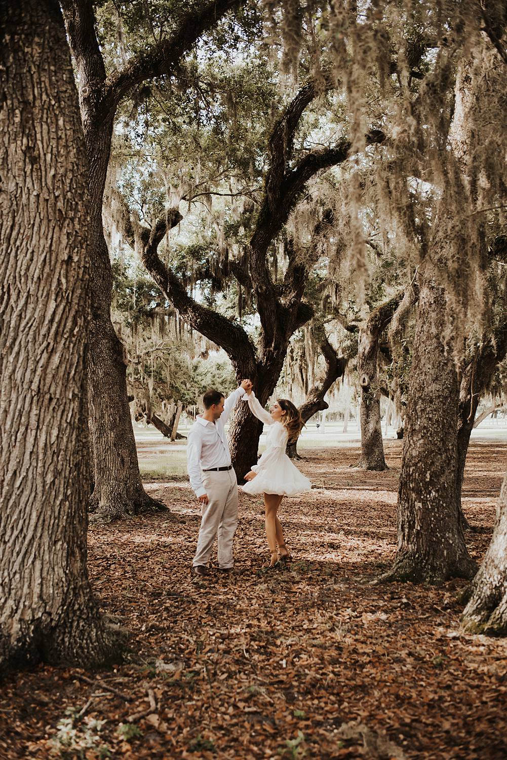Bride and groom under oak trees