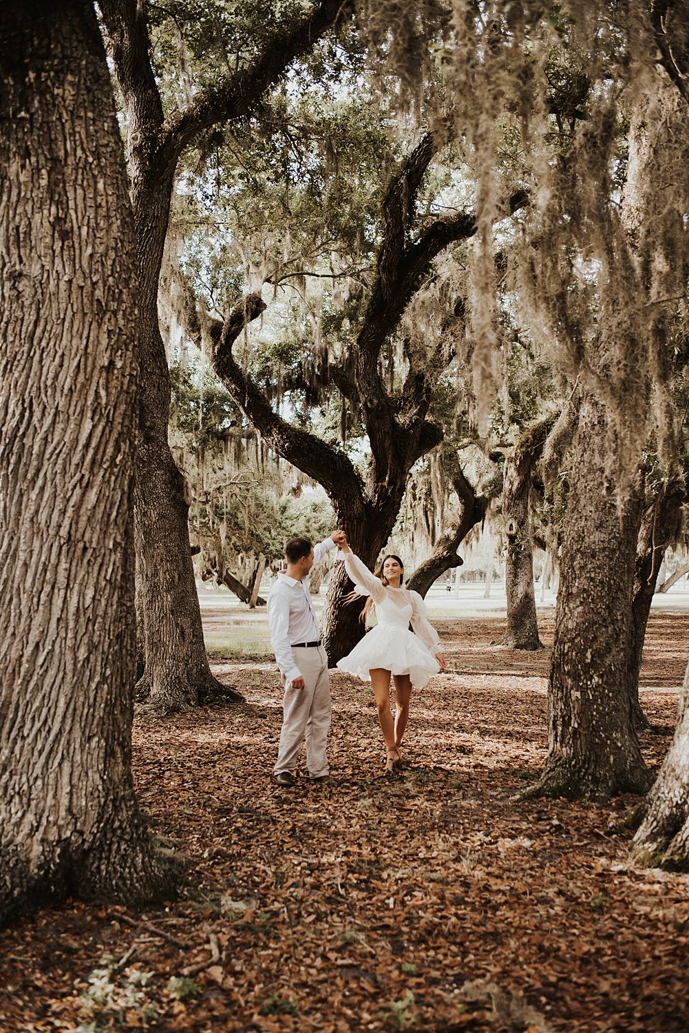 Bride and groom under oak trees
