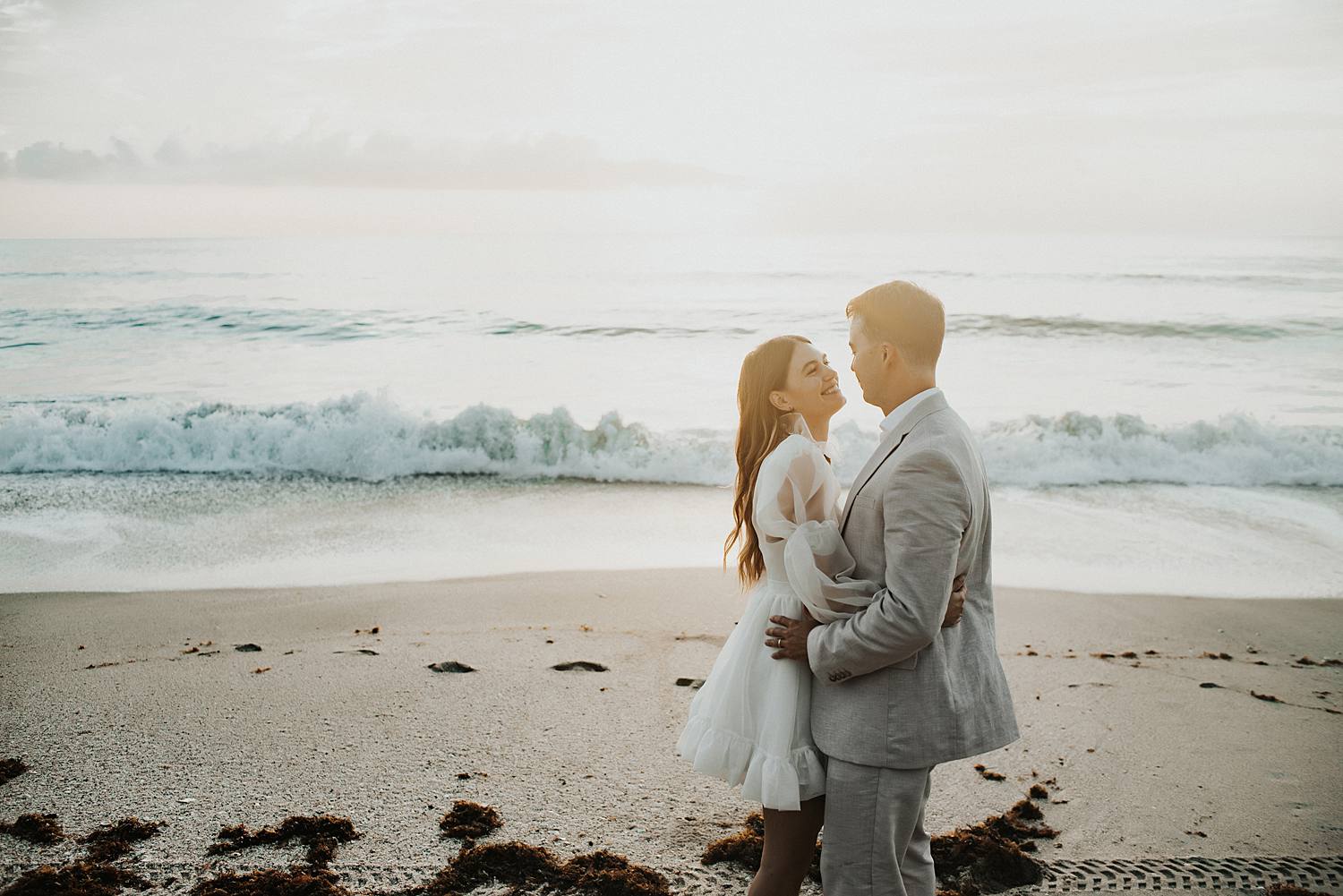 Bride and groom dancing on beach