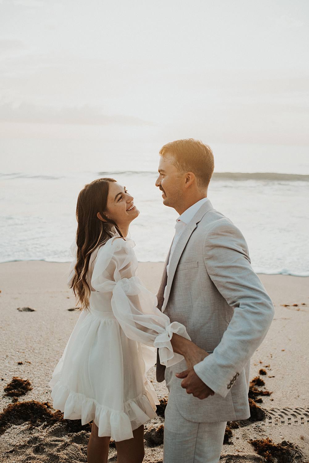 Bride and groom dancing on beach