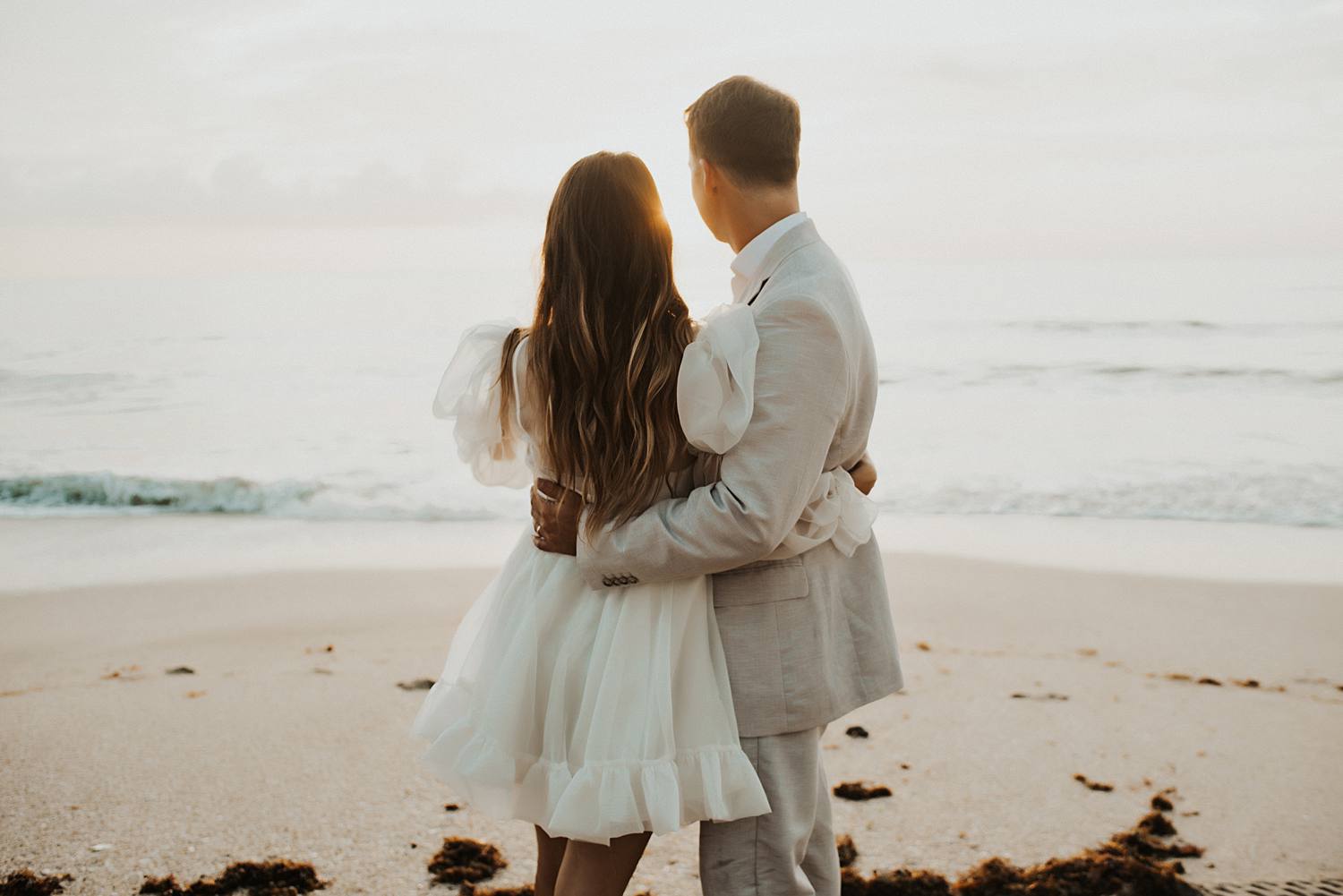 Bride and groom dancing on beach