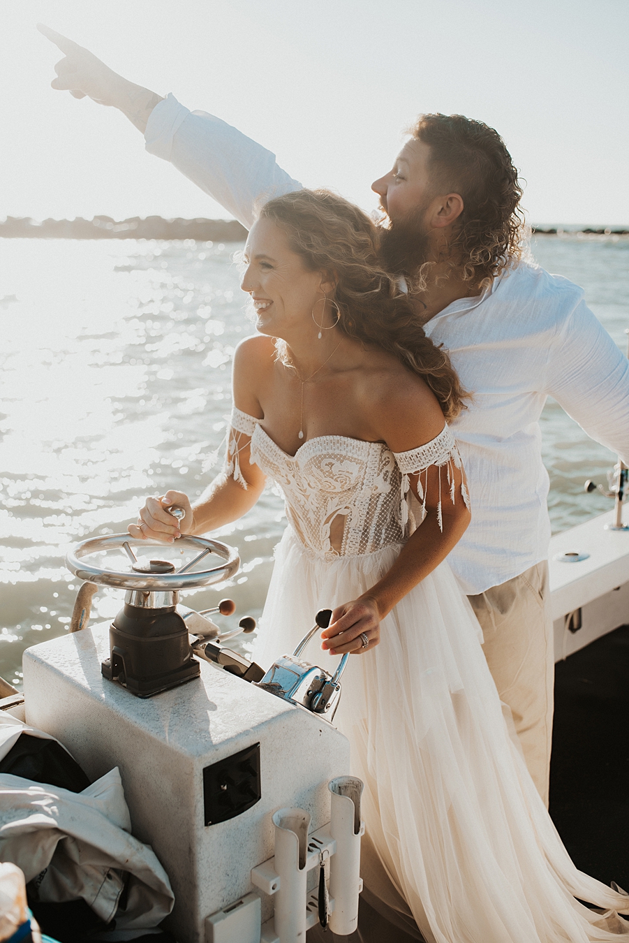 Bride driving boat during elopement