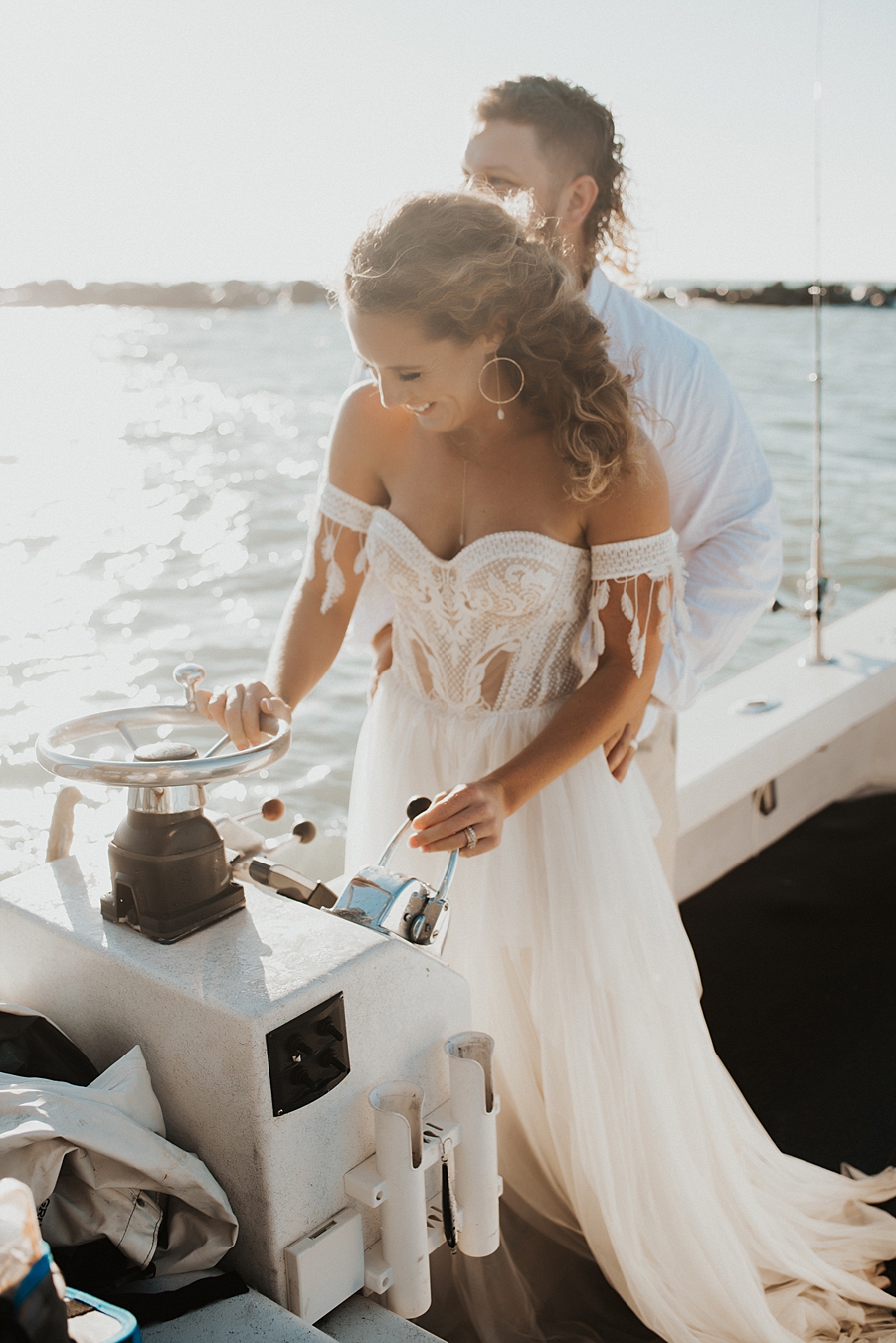 Bride driving boat during elopement