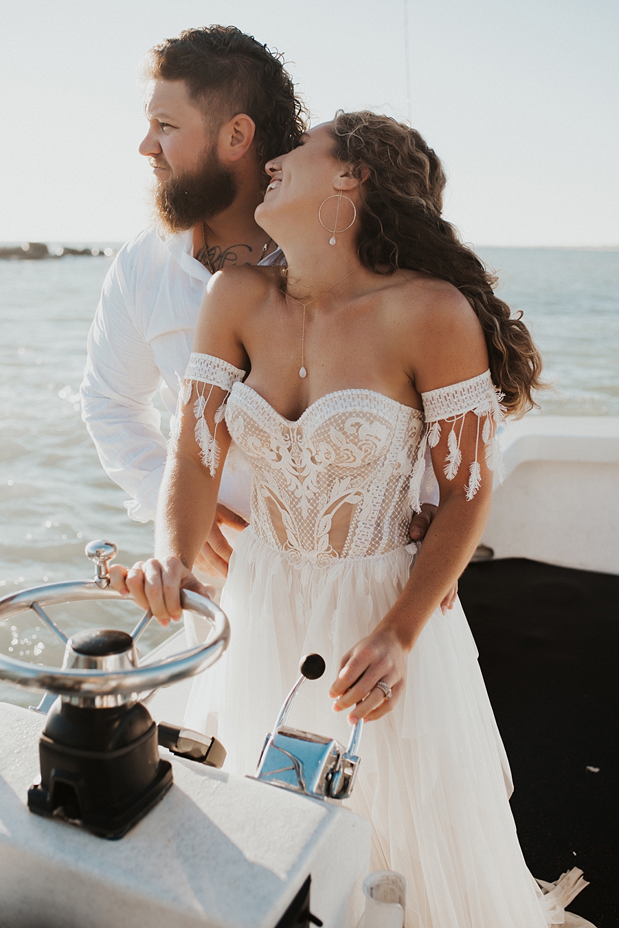 Bride driving boat during elopement