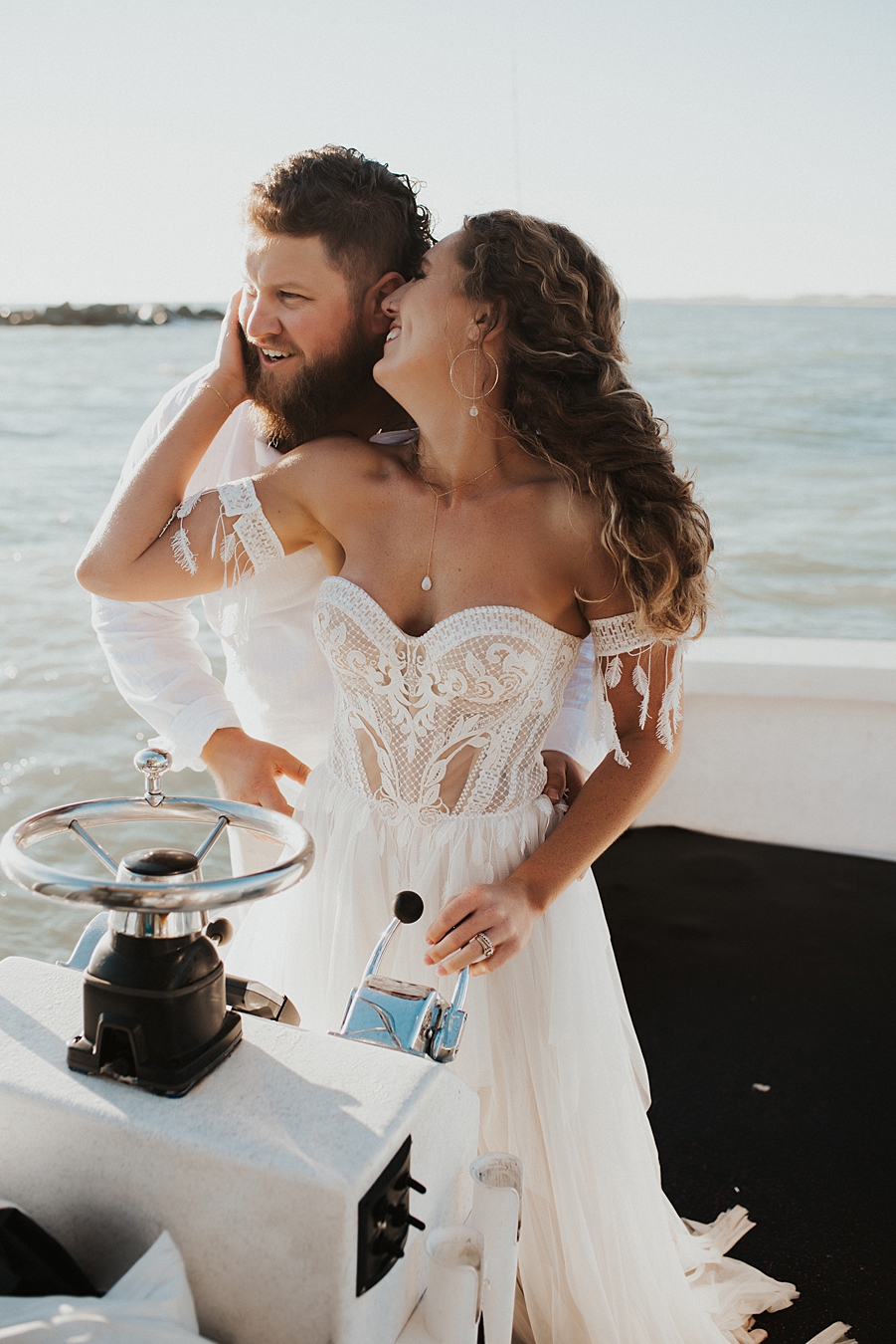 Bride driving boat during elopement