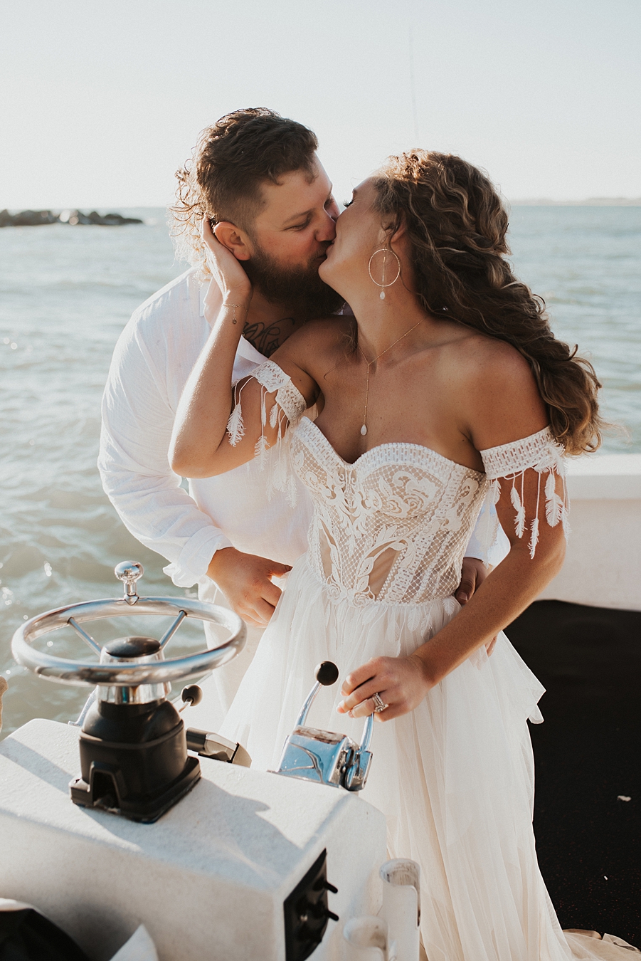 Bride driving boat during elopement