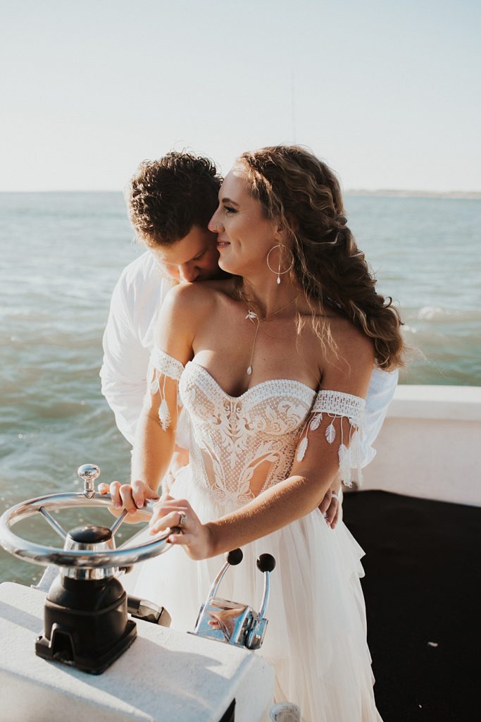 Bride driving boat during elopement