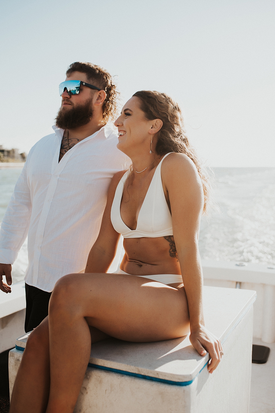 Bride and groom hanging on a boat