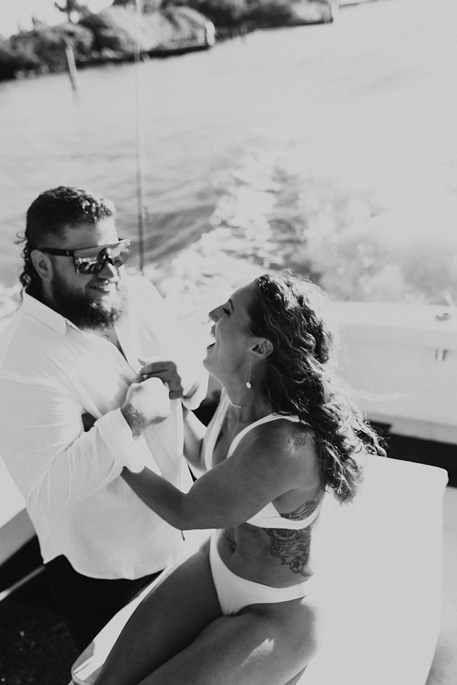 Bride and groom hanging on a boat