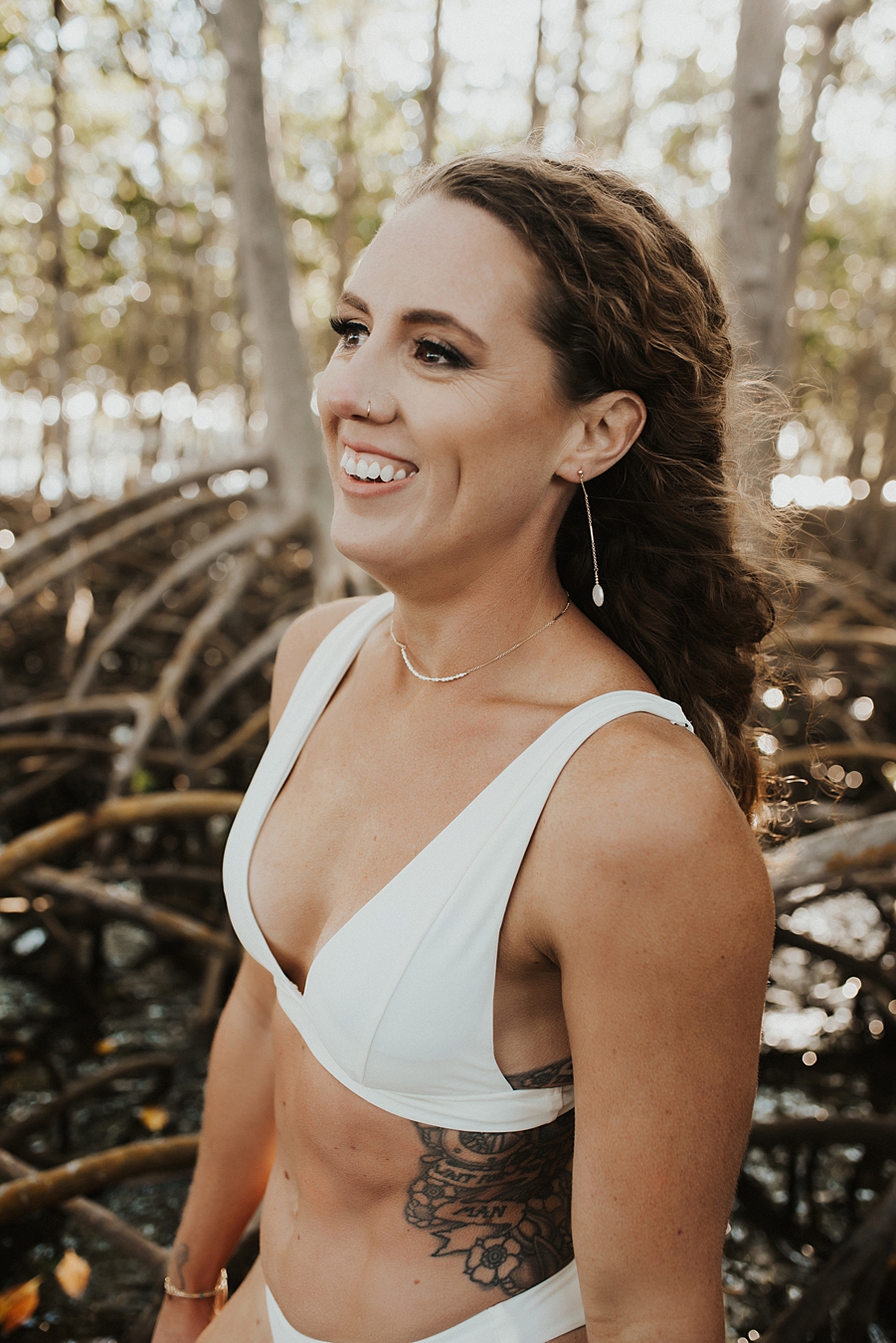 Bride with drop earrings in white bikini