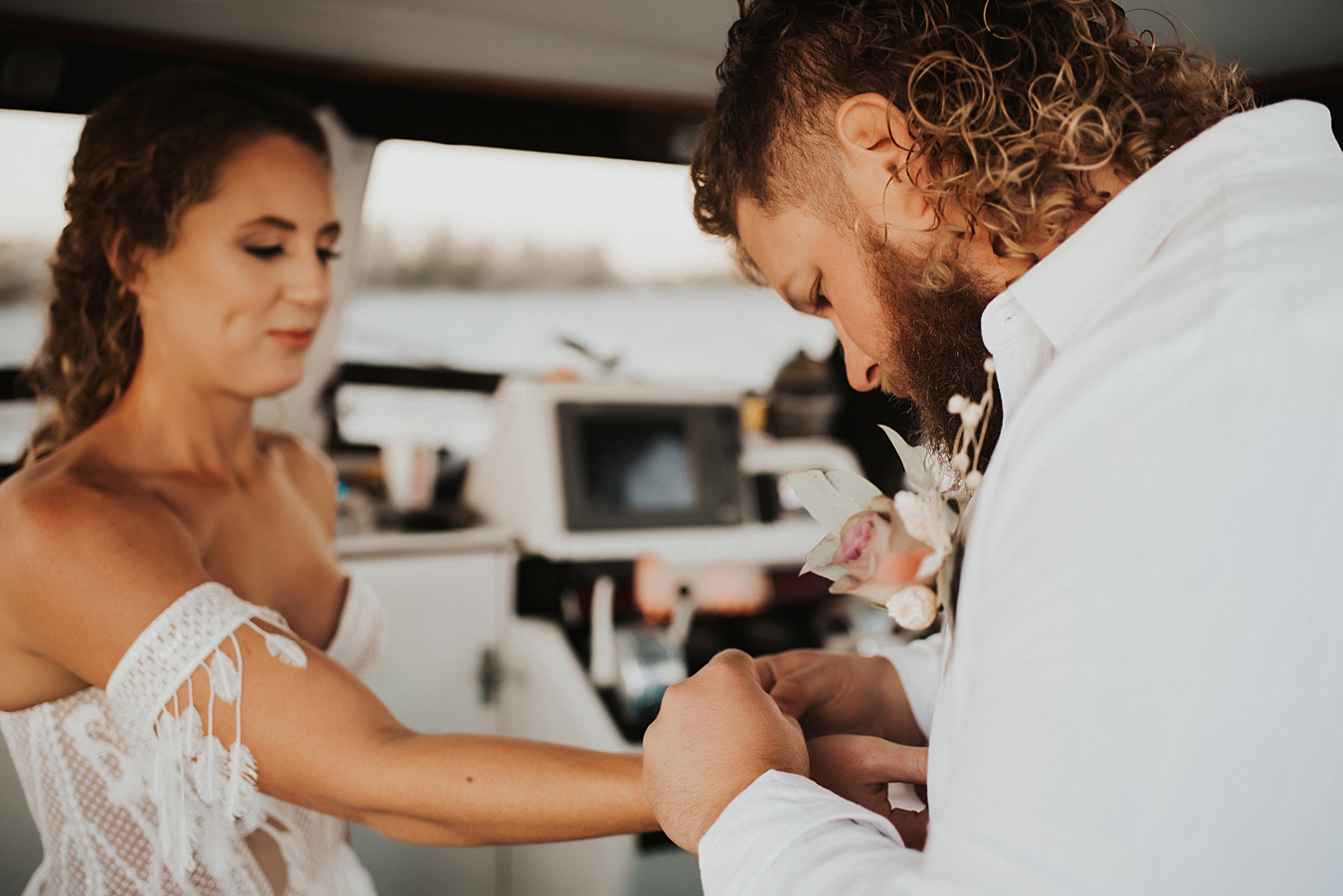 Groom latching bracelet on bride