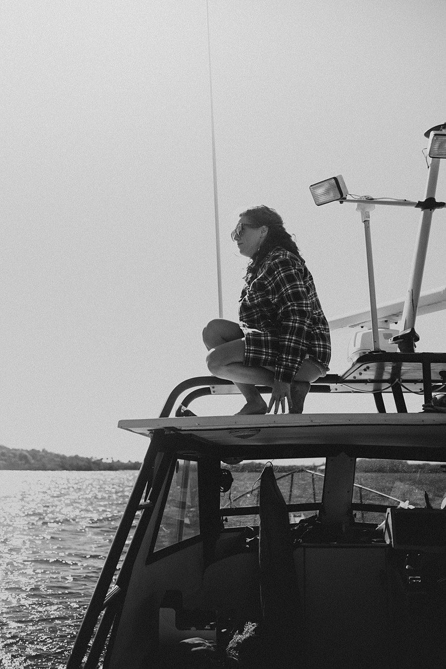 Bride climbing on top of boat