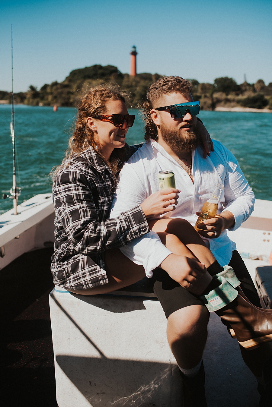 Bride and groom drinking Florida craft beer on boat in front of Jupiter Lighthouse