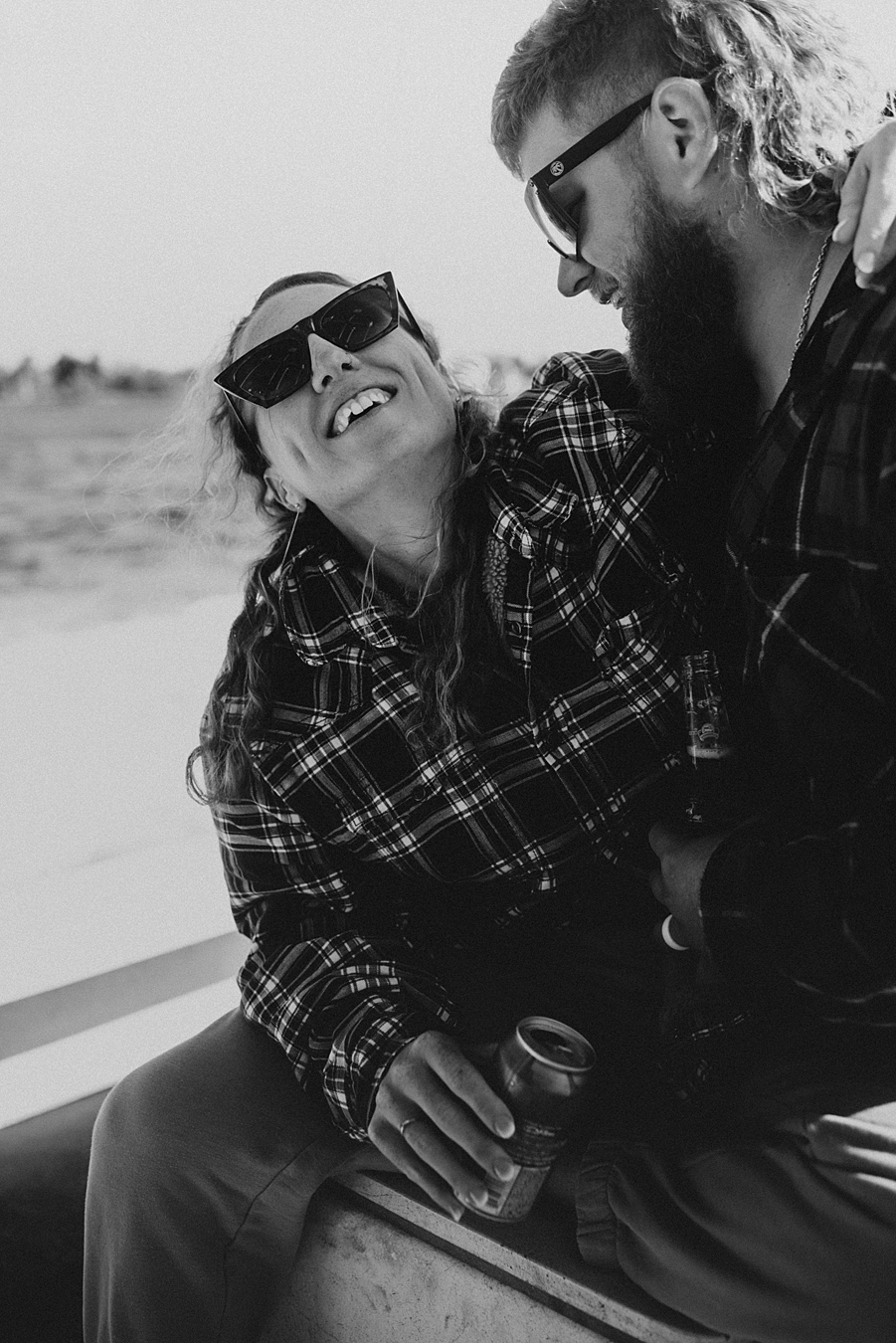 Bride and groom in flannel cuddling on boat