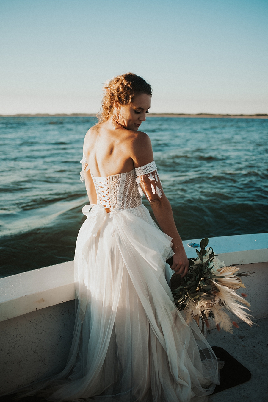 Corset dress with arm cuffs on boat