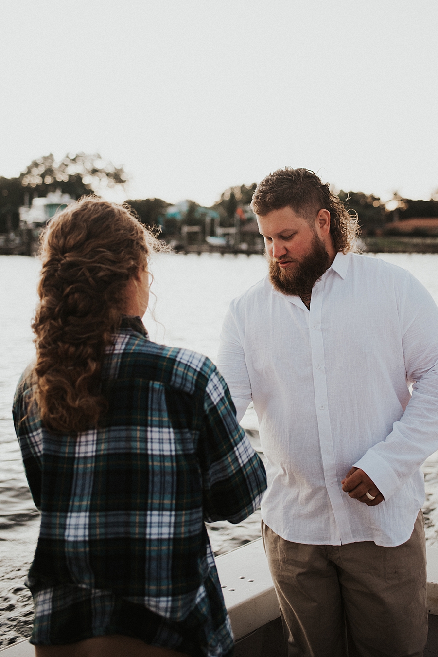 Bride in flannel buttoning grooms shirt