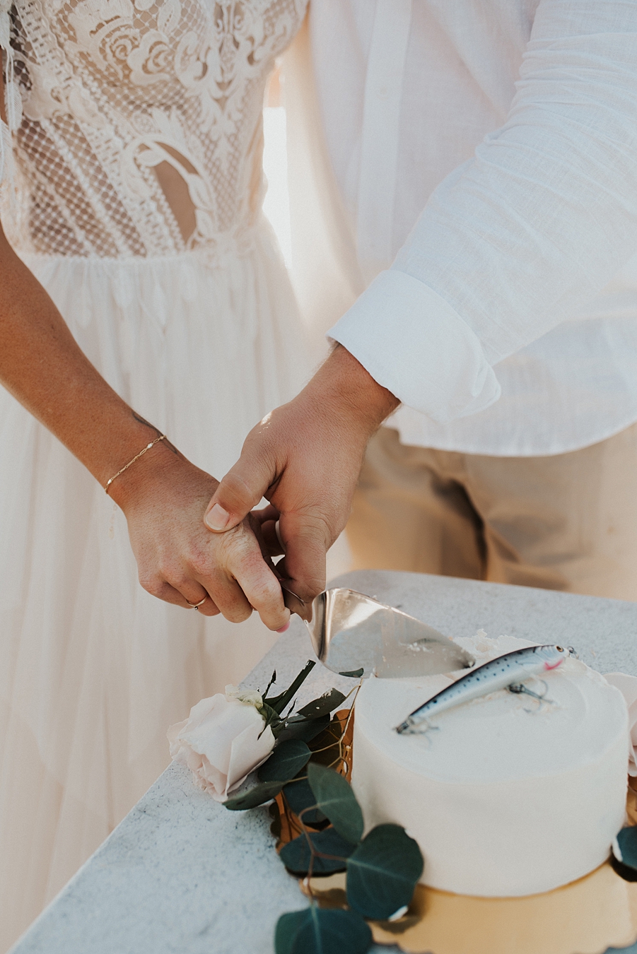 Eloping couple cutting cake