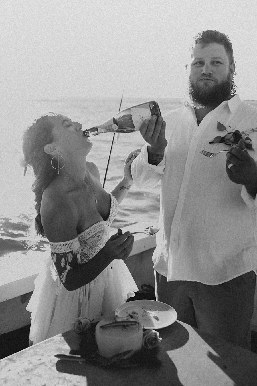 Groom pouring champagne for bride