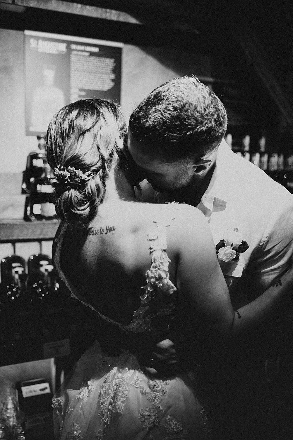 Groom nuzzling into brides neck
