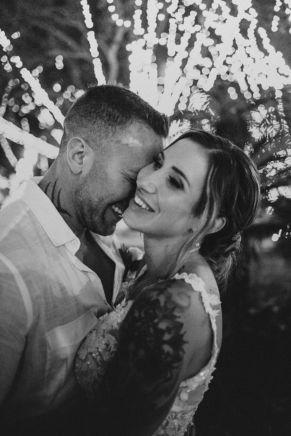 Bride and groom laughing at night of lights
