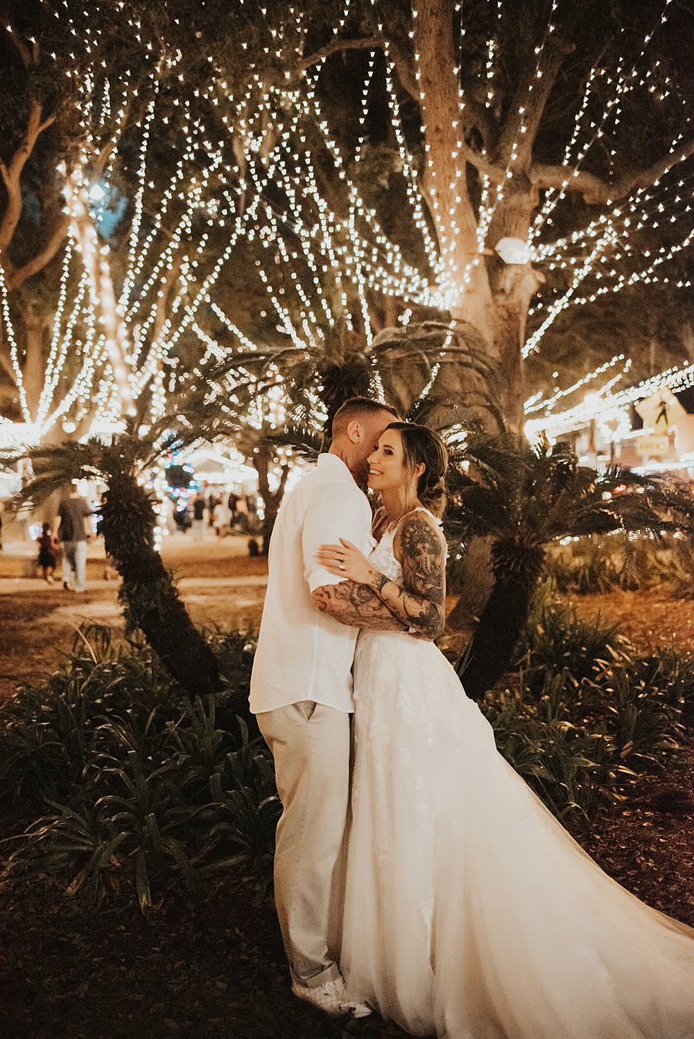 Bride and groom holding eachother at night of lights