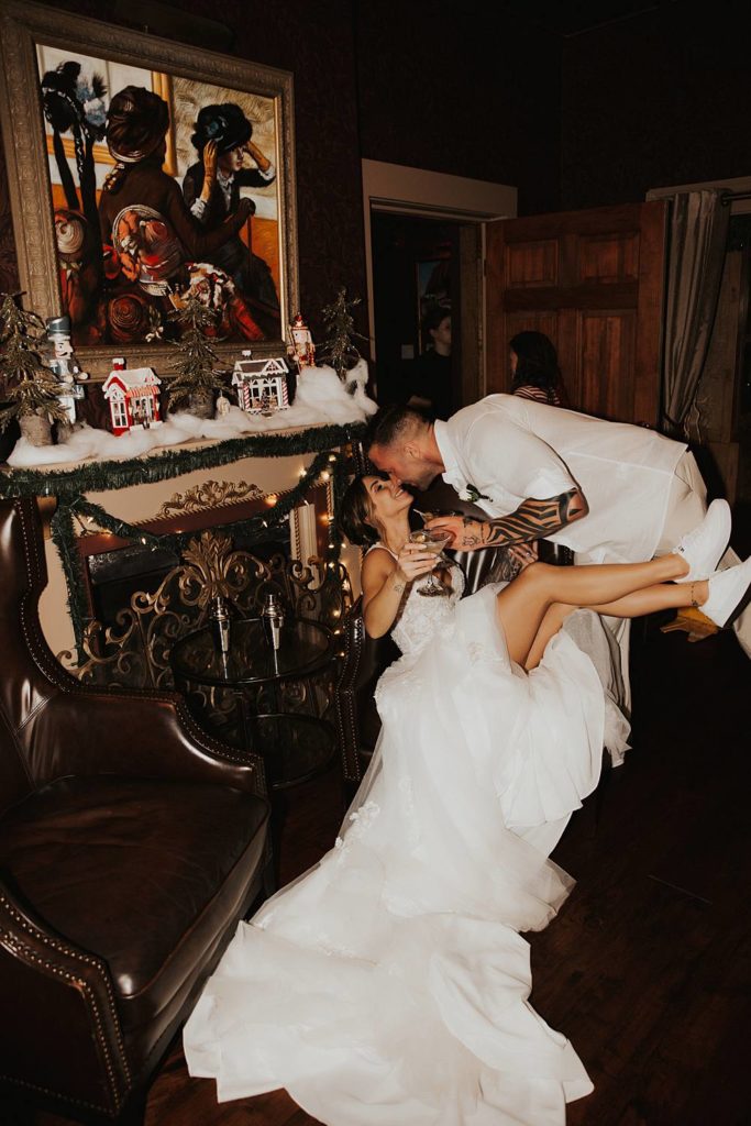 Bride and groom kissing while holding martini glasses at tini martini