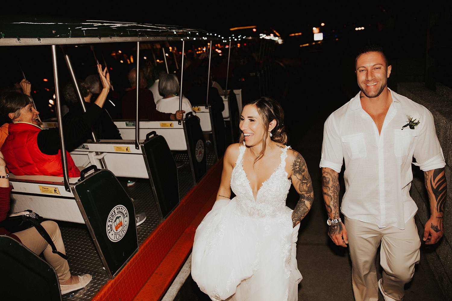 Bride and groom being congratulated by trolley passengers