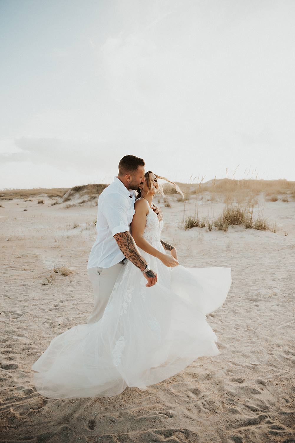 Bride and groom kissing on Saint Anastasia beach