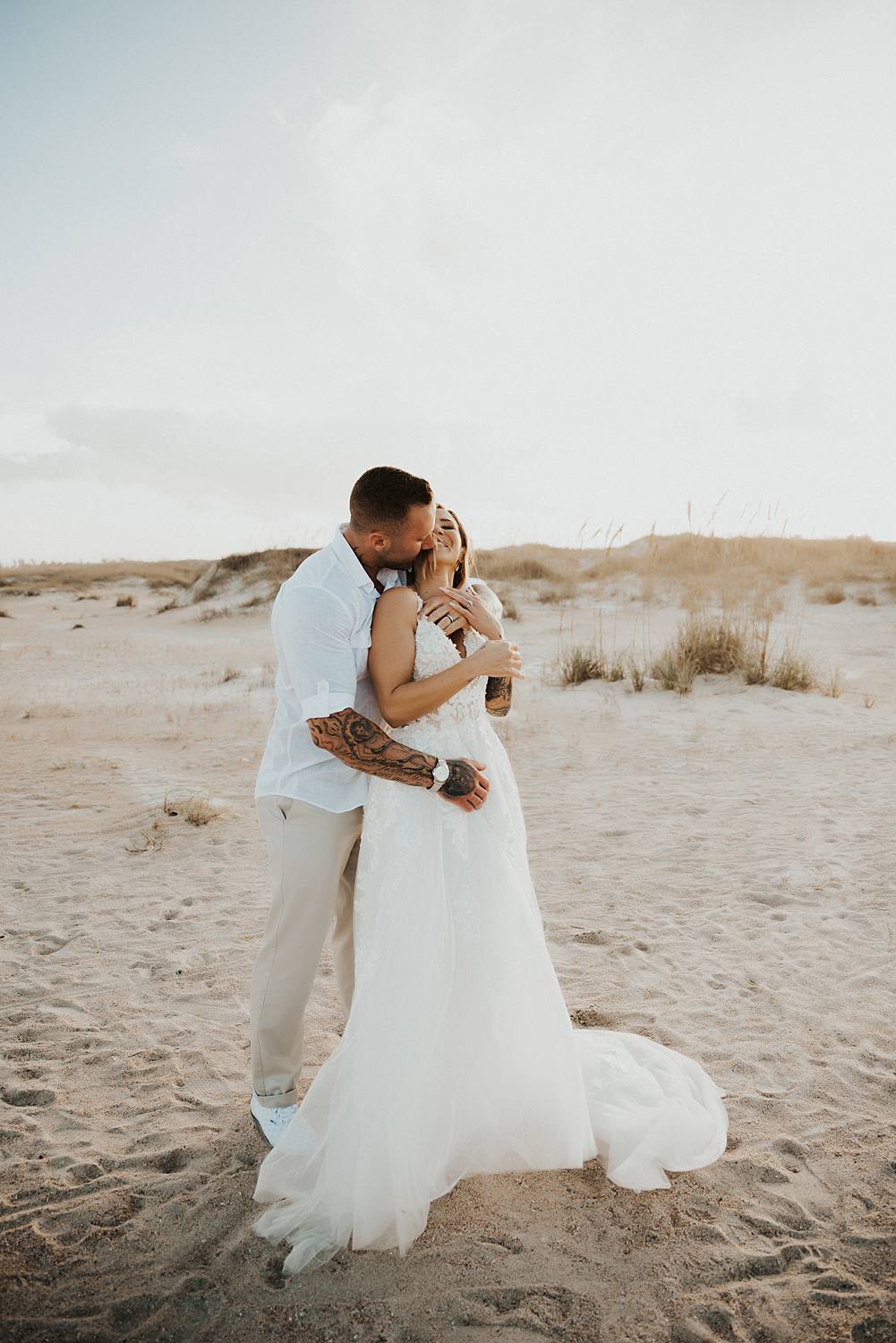 Bride and groom kissing on Saint Anastasia beach
