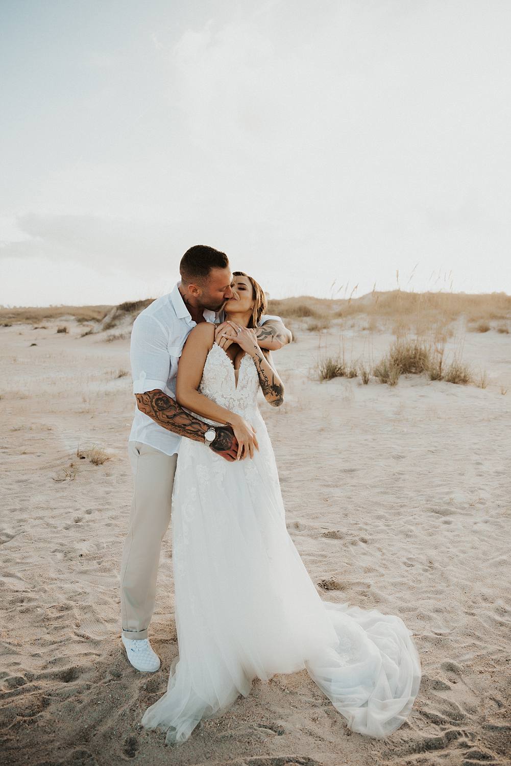 Bride and groom kissing on Saint Anastasia beach