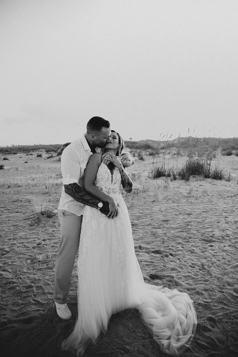 Bride and groom kissing on Saint Anastasia beach