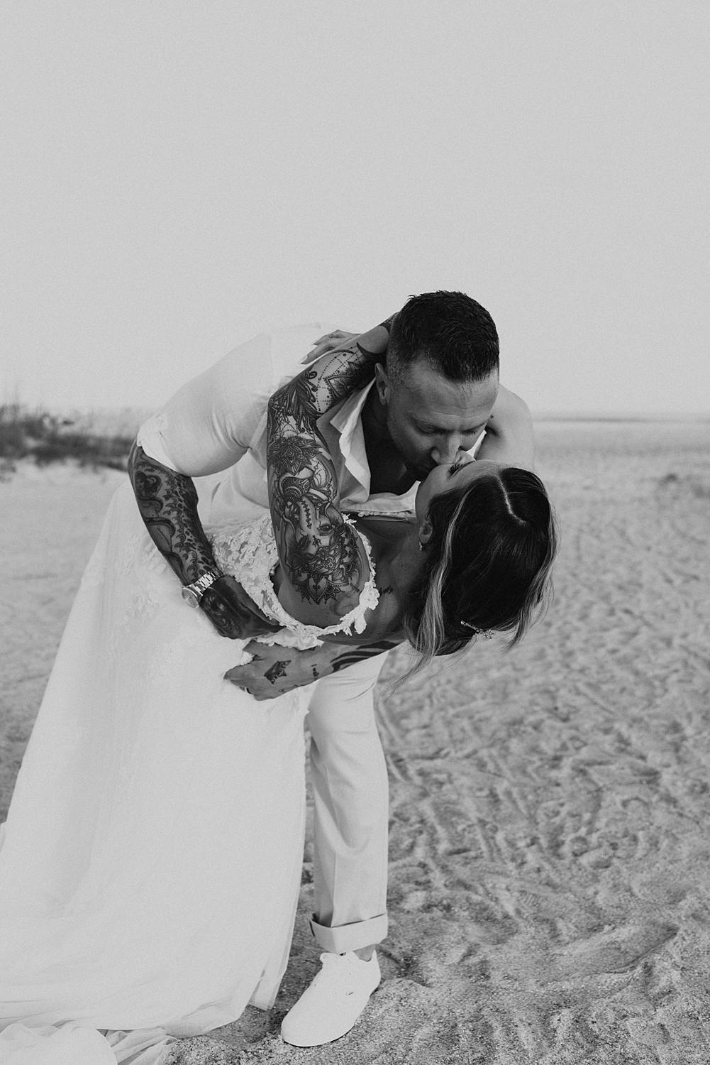 Groom dipping bride on Saint Anastasia beach